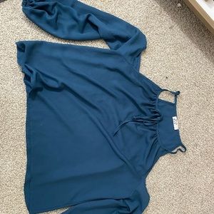 Exposed shoulder blue top